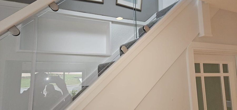 New glazed banisters with a white painted handrail fitted by 6-6-S in Medstead