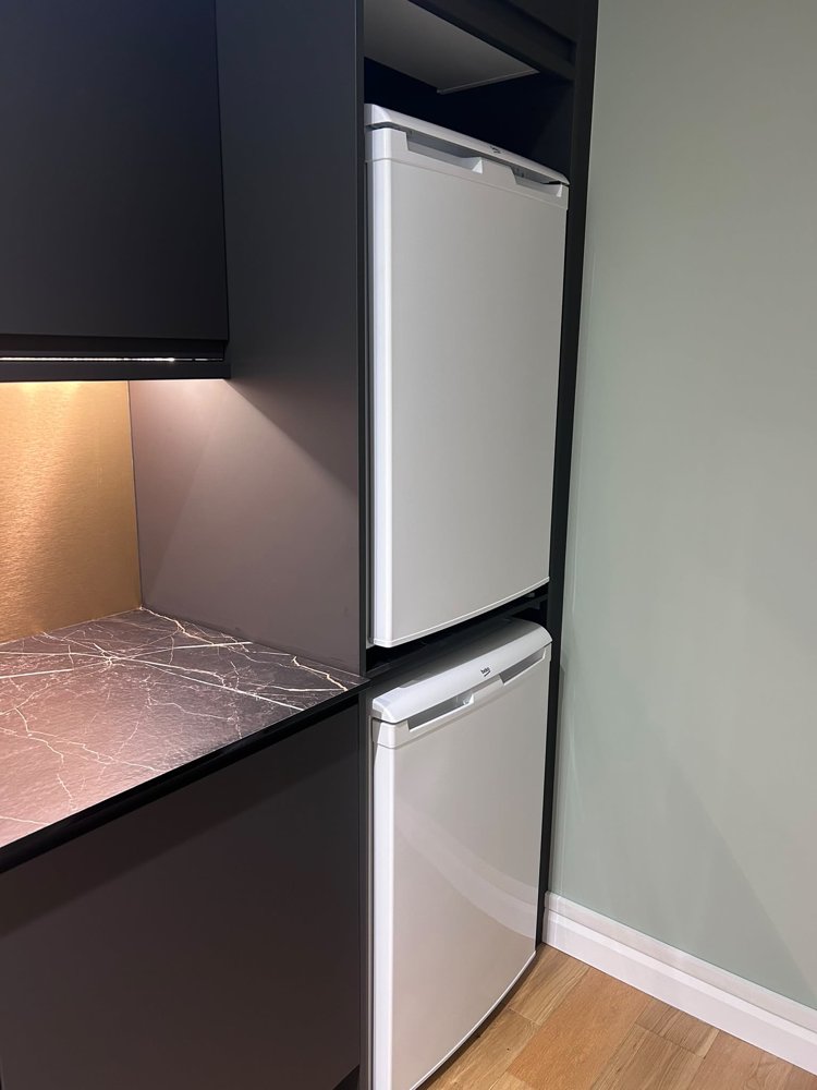 Tall housing unit for the fridge freezer with under-cabinet lighting
